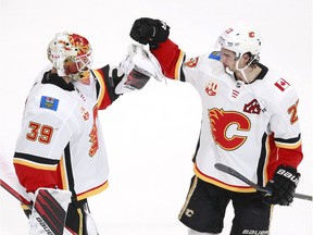 EDMONTON, ALBERTA - AUGUST 04: Cam Talbot #39 of the Calgary Flames celebrates the 6-2 win over the Winnipeg Jets with teammate Sean Monahan #23 after Game Three of the Western Conference Qualification Round prior to the 2020 NHL Stanley Cup Playoffs at Rogers Place on August 04, 2020 in Edmonton, Alberta.