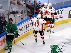 Milan Lucic helps celebrate a Dillon Dube goal last night in a Game 1 victory over the Dallas Stars at Rogers Place in Edmonton.