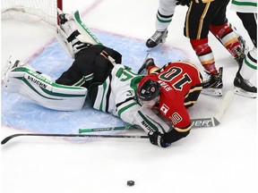 Derek Ryan of the Calgary Flames collides with Anton Khudobin of the Dallas Stars during their Western Conference quarterfinal series of the 2020 NHL Stanley Cup Playoffs at Rogers Place in Edmonton.