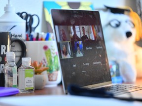 Bottles of hand sanitizer sit next to a laptop showing a Zoom meeting as students begin classes amid the coronavirus pandemic on the first day of the fall 2020 semester at the University of New Mexico on Aug. 17, 2020 in Albuquerque, N.M.