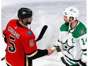 EDMONTON, ALBERTA - AUGUST 20: Mark Giordano #5 of the Calgary Flames and Jamie Benn #14 of the Dallas Stars shake hands following Game Six of the Western Conference First Round during the 2020 NHL Stanley Cup Playoffs at Rogers Place on August 20, 2020 in Edmonton, Alberta, Canada. The Stars defeated the Flames 7-3 to win the Round One Western Playoff series 4-2.