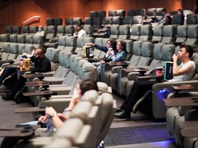 People take their seats inside the Odeon Luxe Leicester Square cinema, on the opening day of the film "Tenet," amid the coronavirus outbreak, in London, Aug. 26, 2020.