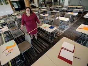 Alberta NDP Education Critic Sarah Hoffman poses in a makeshift classroom, created to illustrate the difficulties teachers and students will face in observing COVID-19 social distancing rules during a return to school this fall, in Edmonton Tuesday Aug. 11, 2020.