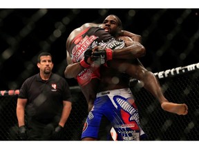 Corey Anderson (blue shorts) picks up Justin Jones in their fight during UFC 181 at the Mandalay Bay Events Center on Dec. 6, 2014 in Las Vegas. Anderson has left the UFC and signed with Bellator. Alex Trautwig/Getty Images