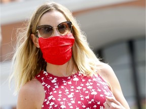 Allison Mones walks out of the downtown Safeway wearing a mask as they became mandatory in Calgary on Saturday, August 1, 2020. Darren Makowichuk/Postmedia