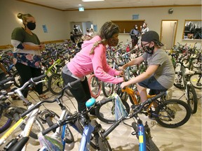 Noah Pike, 9 yrs, is tries out a bike for fit among the dozens of bikes at the YYC Kids Ride second bike giveaway event on  Saturday, August 8, 2020 at the Forest Lawn Community Association.
