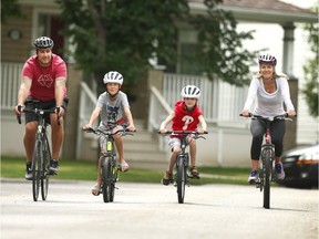 Jordan Witzel (L) Director of the Field of Crosses, joins his wife Lindsey and two sons Slade and Beck in Calgary on Saturday, August 8, 2020 as they prep for a 3km bike ride to raise funds for the Field of Crosses.