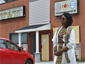 Meheret Worku, who is involved with the Ethiopian community, stands outside the recently vandalized Ethiopian Community Hall on Saturday, Aug. 8, 2020