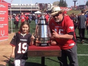 Lee Cawiezel (right) and his daughter Skylar are pictured at a Calgary Stampeders game with the Grey Cup. Cawiezel, of Drumheller, has been a Stampeders fan for 35 years and runs the Calgary Stampeders Fan Page on Facebook.
