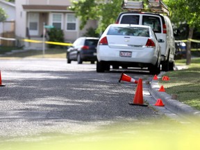 Calgary police hold the scene of a fatal shooting that left two men dead Friday evening on Sandarac Rd. N.W.