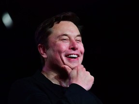 In this file photo taken on March 14, 2019 Tesla CEO Elon Musk reacts during the unveiling of the new Tesla Model Y in Hawthorne, California.