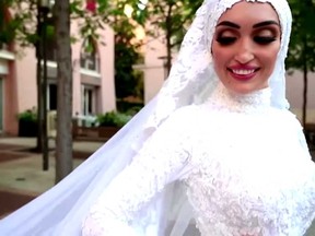 Lebanese bride Israa Seblani stands smiling and posing for her wedding video seconds before the blast in Beirut, Lebanon.