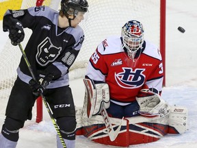 Calgary Hitmen forward Riley Stotts watches a ricocheting puck along with Lethbridge Hurricanes goalie Carl Tetachuk during WHL hockey action at the Saddledome in Calgary on March 1, 2020.  Gavin Young/Postmedia