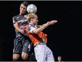 Cavalry FC Dominick Zator (L) and Forge FC Kyle Bekker collide while competing for a high ball on Thursday, August 13, 2020 during the opening game of the Canadian Premier League Island Games soccer action in Charlottetown, Prince Edward Island.  he game ended in a 2-2 draw. The Island Games commence August 13 and finish in mid-September. Canadian Premier League/Chant Photography