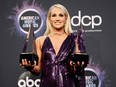 Carrie Underwood poses backstage with awards for Favorite Album-Country for "Cry Pretty" and for Favorite Female Artist-Country.