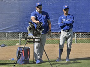 Blue Jays coach Ken Huckaby (left) and manager Charlie Montoyo wait to run catching drills at the team's spring training facilities in Dunedin, Fla., Sunday, Feb. 16, 2020. Steve Nesius/The Canadian Press Files
