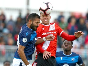Cavalry FC’s Oliver Minatel (right) and FC Edmonton’s Ajay Khabra go up for a ball during Canadian Premier League action at ATCO Field at Spruce Meadows in Calgary on Aug. 16, 2019. The Alberta rivals, along with other CPL teams, are travelling together to Charlottetown, P.E.I., for the The Island Games tournament. Jim Wells/Postmedia
