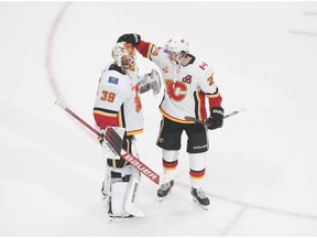 Calgary Flames' goalie Cam Talbot (39) and Sean Monahan (23) celebrate their win over the Winnipeg Jets during third period NHL qualifying round game action in Edmonton, on Tuesday August 4, 2020.