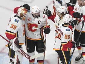 Calgary Flames players celebrate their series-clinching 4-0 win over the Winnipeg Jets at Rogers Place in Edmonton on Thursday, August 6, 2020. Goaltender Cam Talbot, left, made 31 saves in the shutout. Jason Franson/The Canadian Press