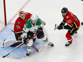 Calgary Flames forward Sam Bennett and goaltender Cam Talbot defend against Dallas Stars forward Corey Perry during Game 6 of their first-round series at Rogers Place in Edmonton on Aug. 20, 2020. Perry Nelson/USA TODAY