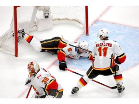 Calgary Flames defenceman Mark Giordano (No. 5) falls into the net during the third period against the Dallas Stars in Game 5 of the first round of the NHL's Western Conference quarterfinal at Rogers Place.