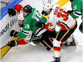 Aug 18, 2020; Edmonton, Alberta, CAN; Dallas Stars center Jason Dickinson (18) checks Calgary Flames defenseman TJ Brodie (7) during the third period in game five of the first round of the 2020 Stanley Cup Playoffs at Rogers Place. Mandatory Credit: Gerry Thomas-USA TODAY Sports ORG XMIT: USATSI-429707