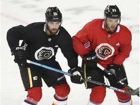 Flames Erik Gustafsson (L) lines up against Alan Quine during Calgary Flames NHL training camp at the Saddledome in Calgary on Thursday, July 16, 2020. Jim Wells/Postmedia