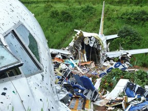 A security official inspects the site where a passenger plane crashed when it overshot the runway at the Calicut International Airport in Karipur, in the southern state of Kerala, India, August 8, 2020.