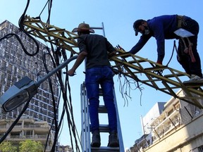 Workers fix damaged cables following Tuesday's massive blast in Beirut's port area, Lebanon, August 7, 2020.