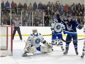 Canmore Eagle Owen Reith cheers after Nolan Steer's shot hits the net to score on the Calgary Canucks in the first period of their AJHL game at the Banff Fenlands Arena on Wednesday, January 23, 2019. The game was sold out with standing room only in Banff. The Canucks won the game 8-3. photo by Pam Doyle/pamdoylephoto.com