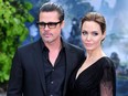 This file photo taken on May 8, 2014 shows actress Angelina Jolie (right) along with her the-husband actor Brad Pitt as they arrive for the premiere of the film "Maleficent" at Kensington Palace in London.