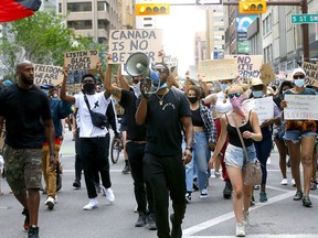 Hundreds march in a Black Lives Matter protest in downtown Calgary on Thursday, Aug. 6, 2020.