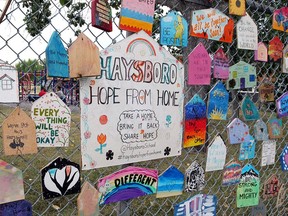 A collage of messages hang from the fence of Hasbro Elementary School in southwest Calgary on Thursday, Aug. 20, 2020.