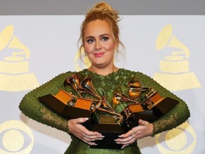 Adele holds the five Grammys she won including Record of the Year for "Hello" and Album of the Year for "25" during the 59th Annual Grammy Awards in Los Angeles, California, U.S. , February 12, 2017.