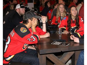 Fans react with shock and dismay at the National on 17 Ave. S.W. as Calgary Flames lose in overtime to the Anaheim Ducks in Game 5 of their series in this photo from Sunday May 10, 2015. File photo from Mike Drew/Postmedia.