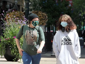 Katrin Bradshaw and Gianna Reid are seen walking along Stephen Ave. SW wearing masks on a warm afternoon. Monday, August 10, 2020.