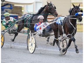 Major Custard and driver J Brandon Campbell leads Speaking of Art and driver Keith L. Clark down the final stretch to win the Ralph Klein Memorial race at Century Downs Race Track in Calgary on Saturday, August 29, 2020  Gavin Young/Postmedia