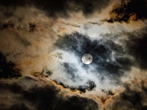 The moon finally makes it past the clouds near Cluny, Alta., on Tuesday, Sept. 1, 2020.