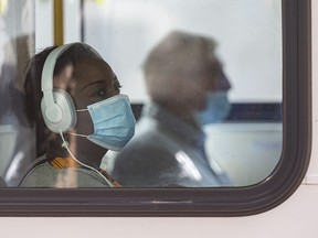 A masked passenger rides a Calgary Transit bus on Friday, September 4, 2020.