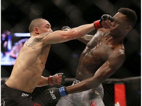 Robert Whittaker and Israel Adesanya fight in a middleweight title bout during UFC 243 at Marvel Stadium on October 06, 2019 in Melbourne, Australia.