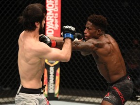Calgary’s Hakeem Dawodu punches Zubaira Tukhugov during their featherweight bout at UFC 253. Josh Hedges/Zuffa LLC via Getty Images