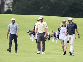 Canadians’ Adam Hadwin, Mackenzie Hughes and Corey Conners walk up the 11th fairway during the first round of the 120th U.S. Open Championship on Thursday at Winged Foot Golf Club in Mamaroneck, New York