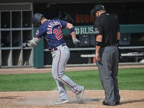 Josh Donaldson of the Minnesota Twins kicks dirt on umpire Dan Bellino after hitting a home run following an argument over a called strike in the 6th inning against the Chicago White Sox at Guaranteed Rate Field on Sept. 17, 2020 in Chicago, Ill.