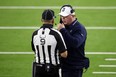Dallas Cowboys head coach Mike McCarthy talks with line judge Mark Perlman during Sunday night's game against the Rams.