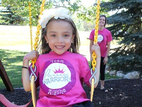 Five-year old Alysha swings with her mom Robin Somji at their Springbank home. Alysha has been living with a kidney disease for years and the family have become acting fundraisers for research for the disease.