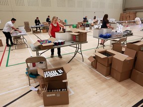 File photo: Volunteers pack care boxes at the Calgary Police Foundation YouthLink building on Wednesday, June 17, 2020.