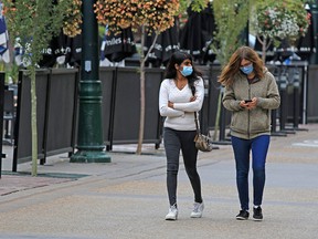Calgarians walk in downtown Calgary on a cool day, Monday, September 14, 2020.