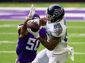 Tennessee Titans tight end MyCole Pruitt (85) catches a pass while being defended by Minnesota Vikings linebacker Eric Wilson (50) at U.S. Bank Stadium.