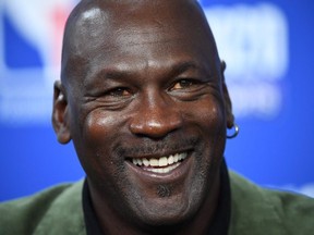 In this file photo taken on January 24, 2020 former NBA star and owner of Charlotte Hornets team Michael Jordan looks on as he addresses a press conference ahead of the NBA basketball match between Milwaukee Bucks and Charlotte Hornets at The AccorHotels Arena in Paris.