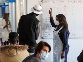 A health worker talks to a vaccine trials' volunteer before he is tested for the coronavirus disease (COVID-19) and takes part of the country's human clinical trial for potential vaccines at the Wits RHI Shandukani Research Centre in Johannesburg, South Africa, Aug. 27, 2020.